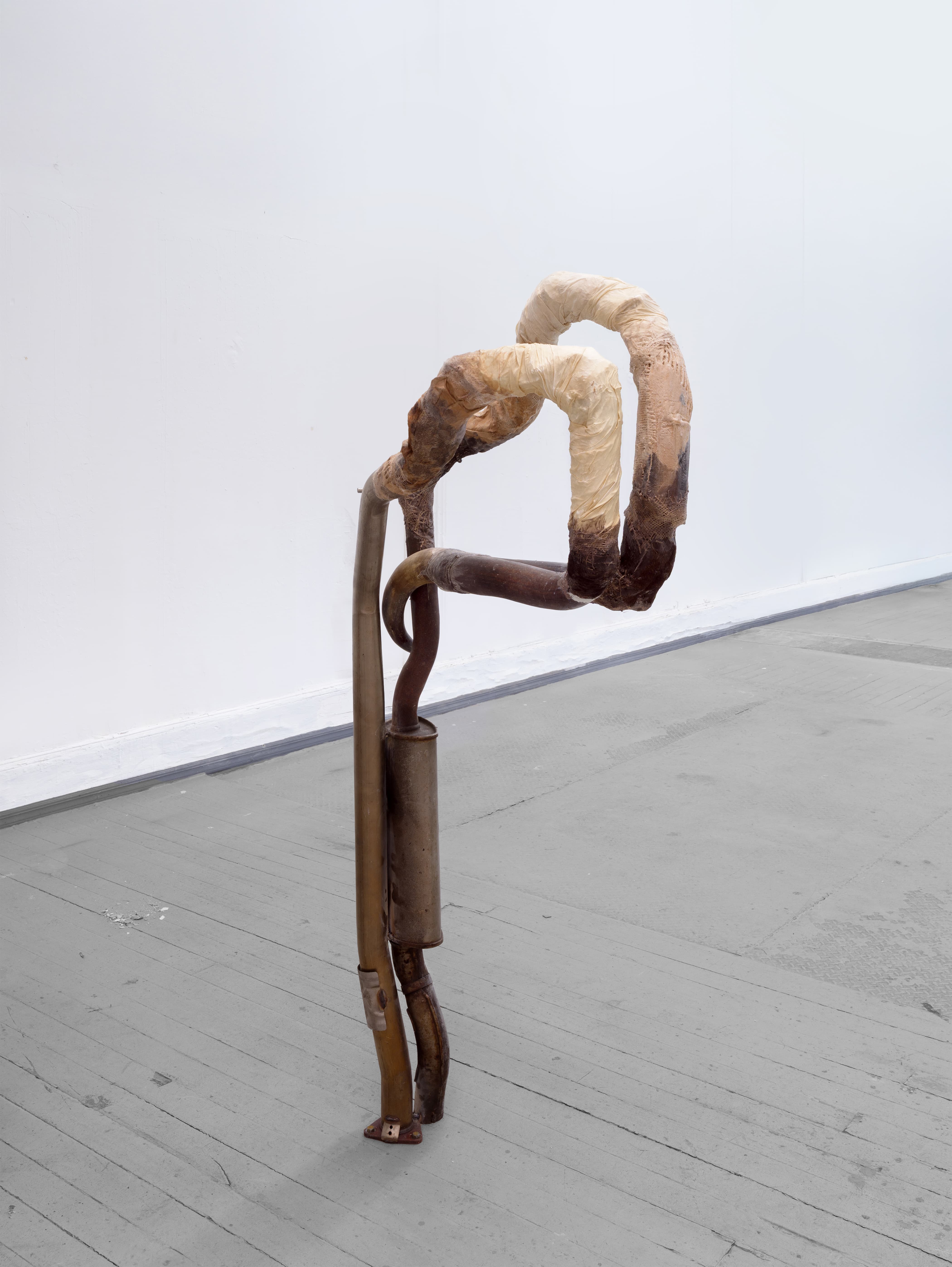 Mónica Mays, <i>rodeos y revolveres</i>, 2026. Found exhaust pipes, muffler, vellum, bull horn, animal hide, wax, acrylic, 63 1/2 x 32 x 13 in (161.5 x 81.5 x 33 cm)